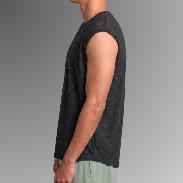 Side profile of a man wearing a dark heather gray sleeveless antibacterial pyjama top against a gray gradient background.
